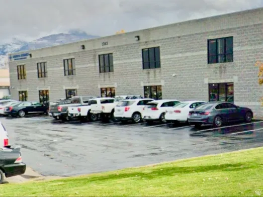 View of apartment building / complex with uncovered parking