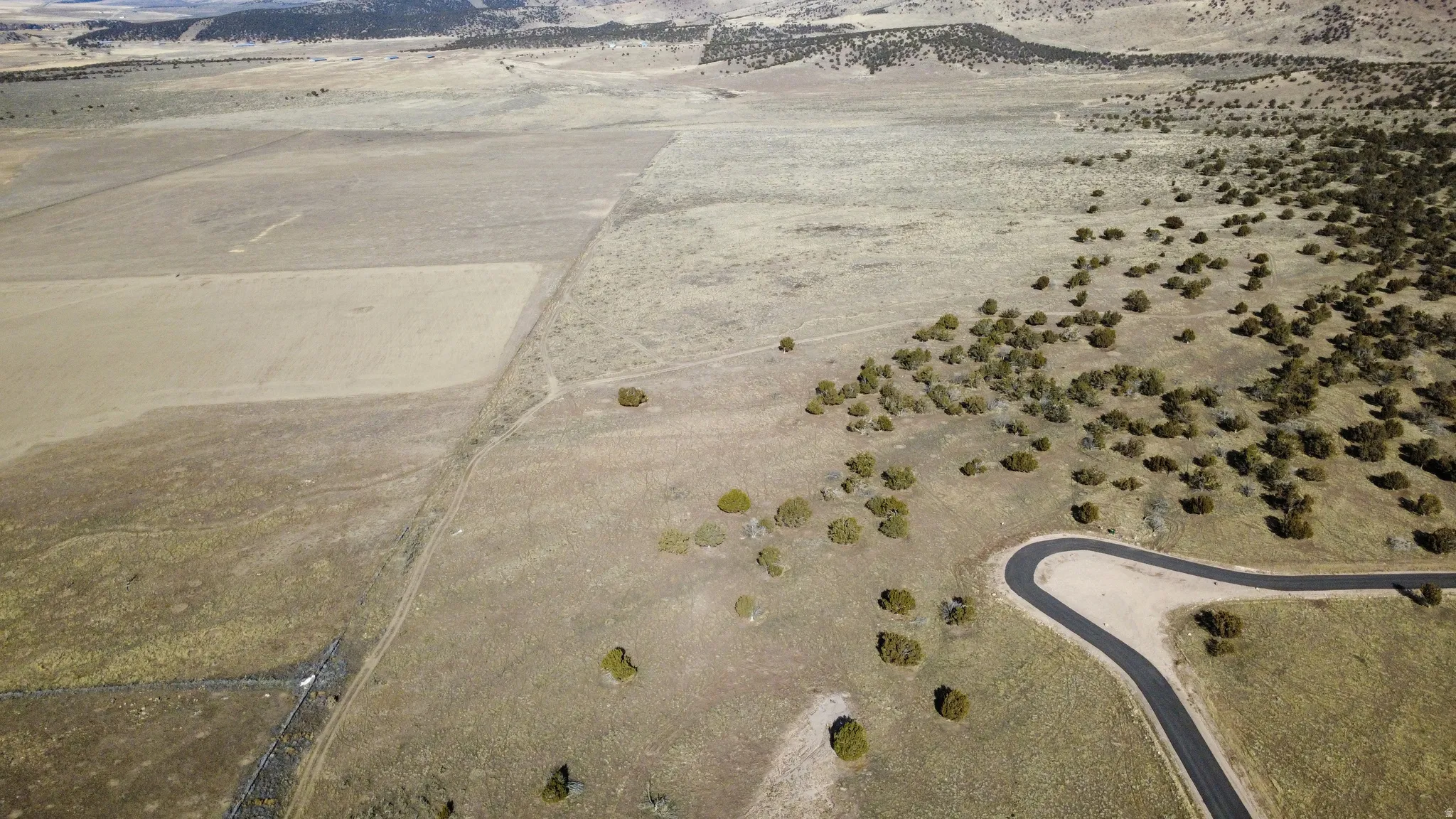 Aerial view of property and surrounding area featuring rural landscape and a desert landscape
