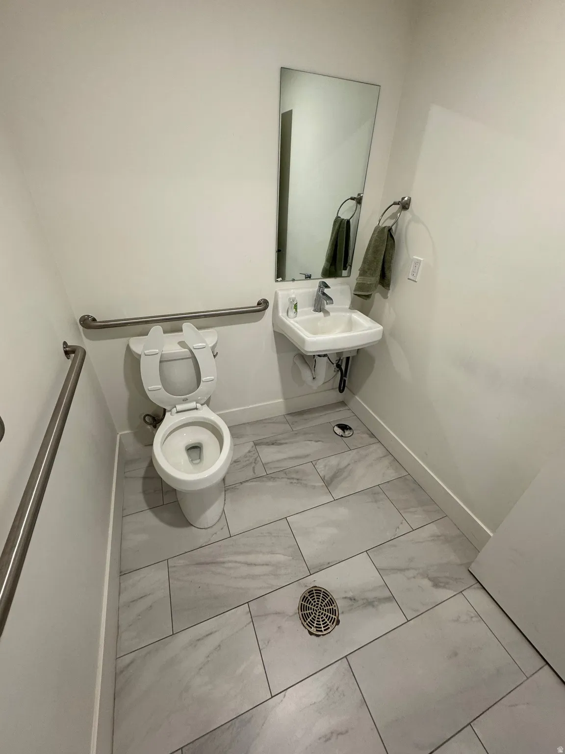 Bathroom with toilet and light marble finish floors