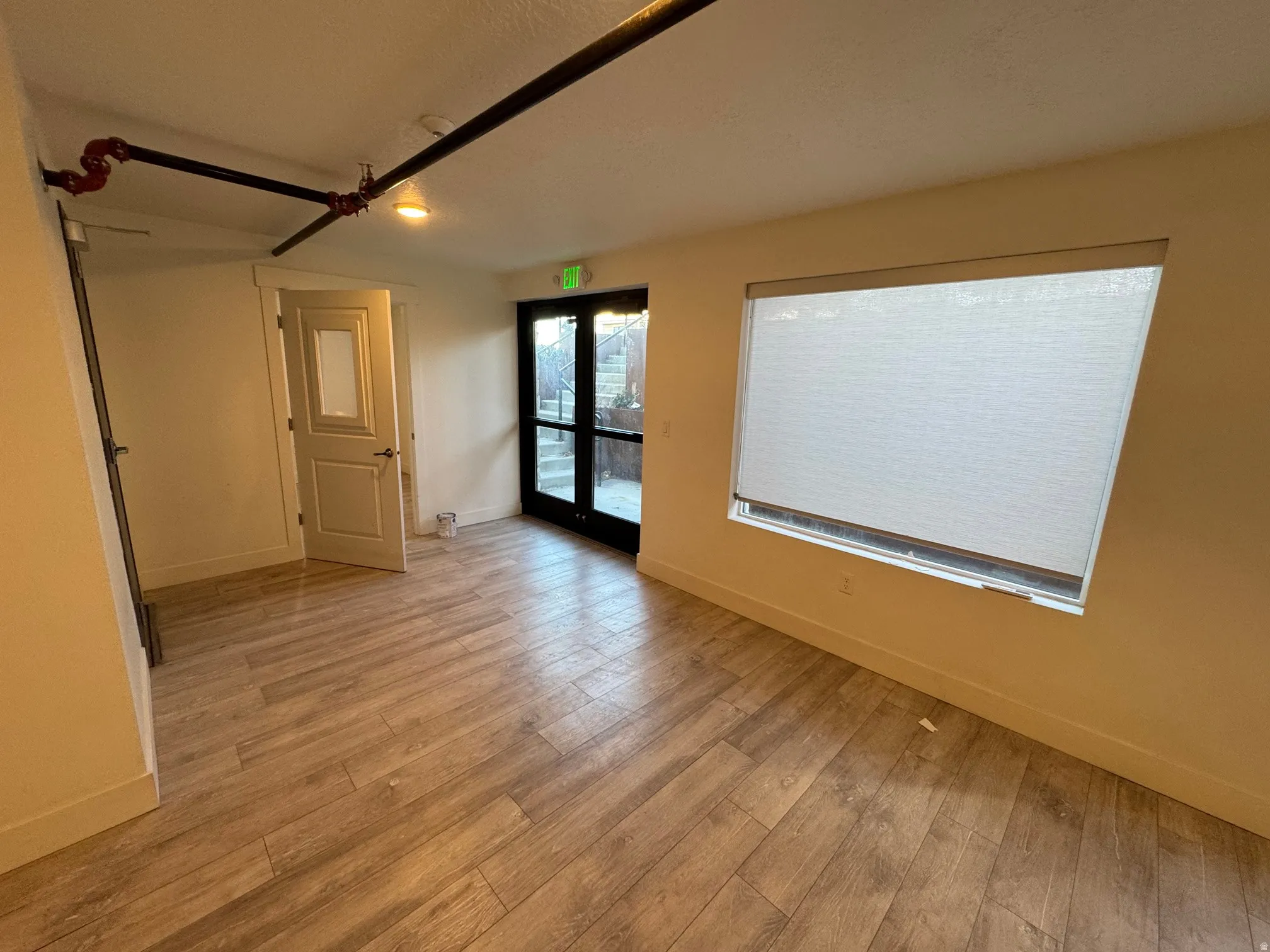 Spare room with baseboards and light wood-style floors