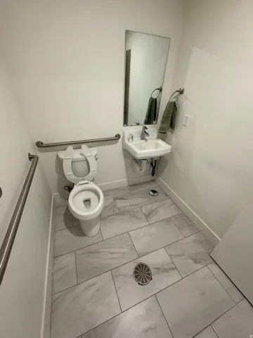 Bathroom with toilet and light marble finish floors