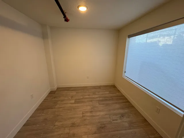Spare room with light wood-style floors and a textured ceiling
