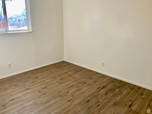 Unfurnished room with wood finished floors