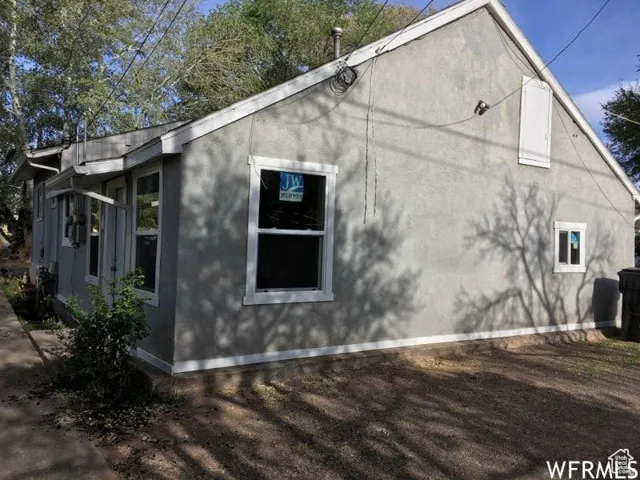 View of side of home with stucco siding