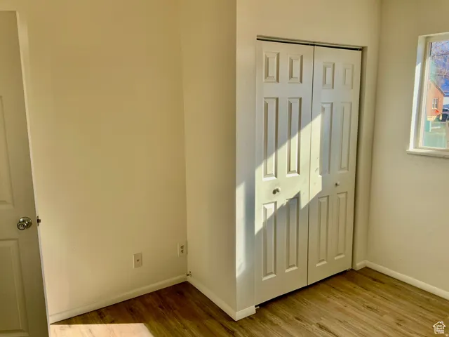 Unfurnished bedroom with light wood-style flooring and a closet