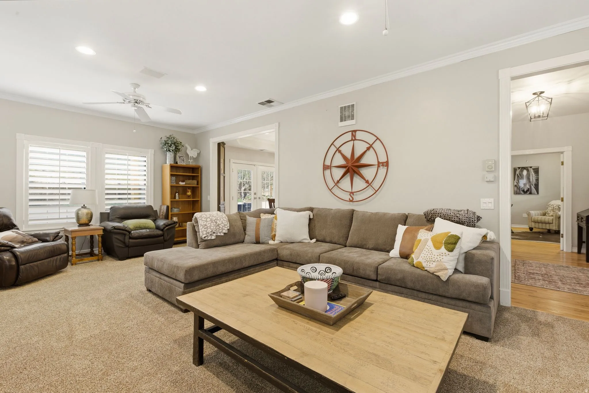 Living area featuring crown molding, ceiling fan, recessed lighting, plenty of natural light, and light carpet