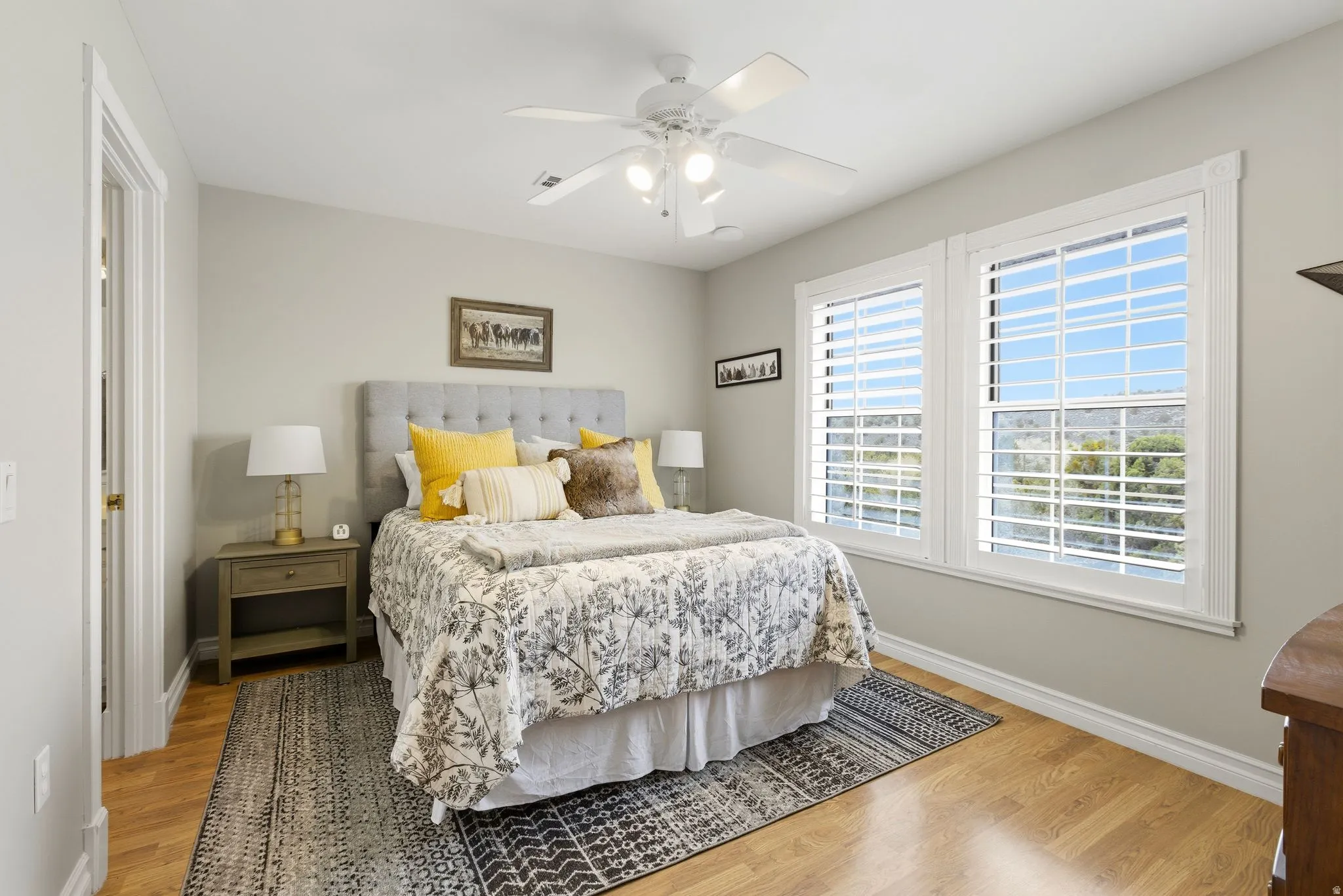 Bedroom with light wood-type flooring and a ceiling fan