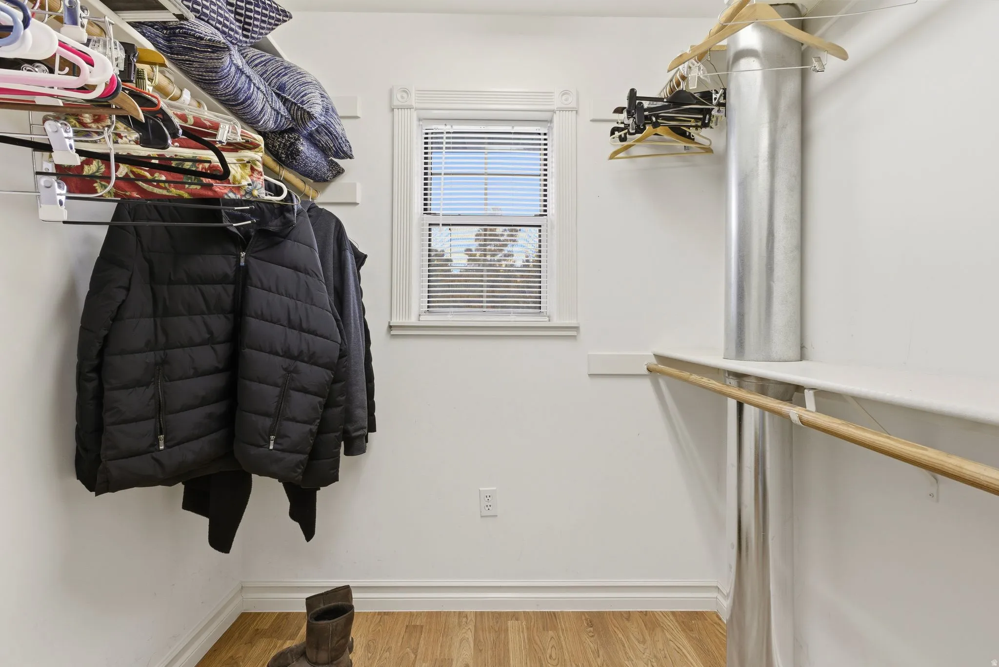 Walk in closet with wood finished floors