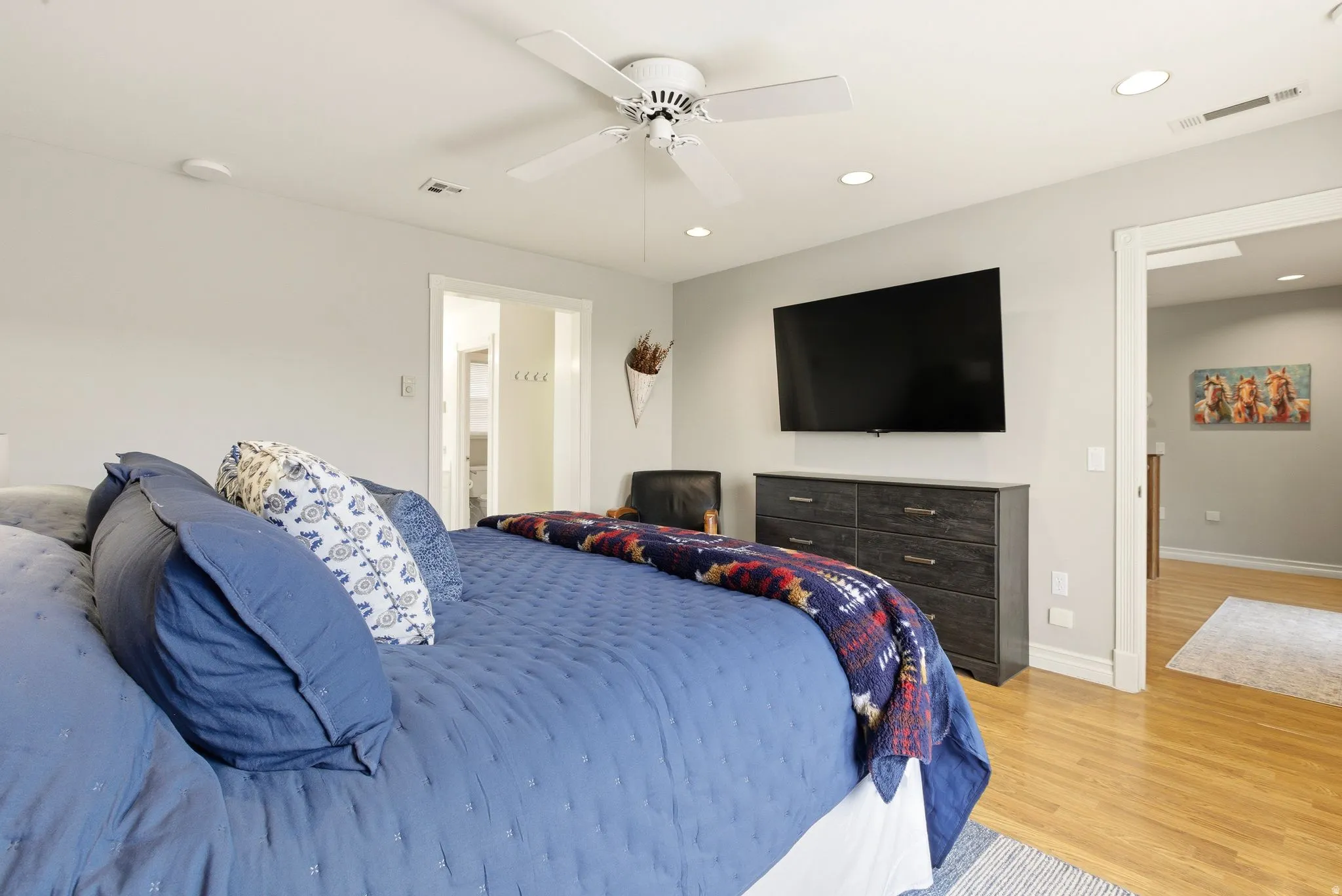 Bedroom with a ceiling fan, recessed lighting, and wood finished floors