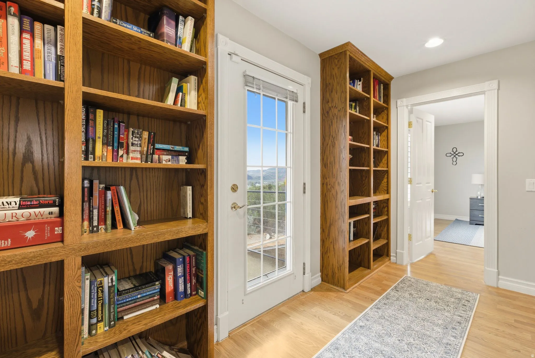 Living area with light wood-style floors and recessed lighting