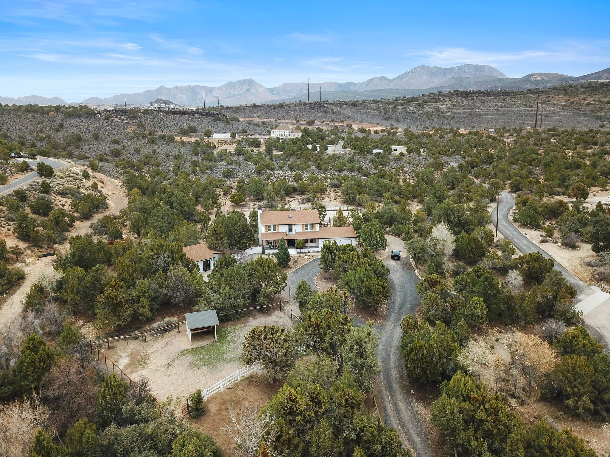 Aerial view of property and surrounding area featuring a mountain backdrop