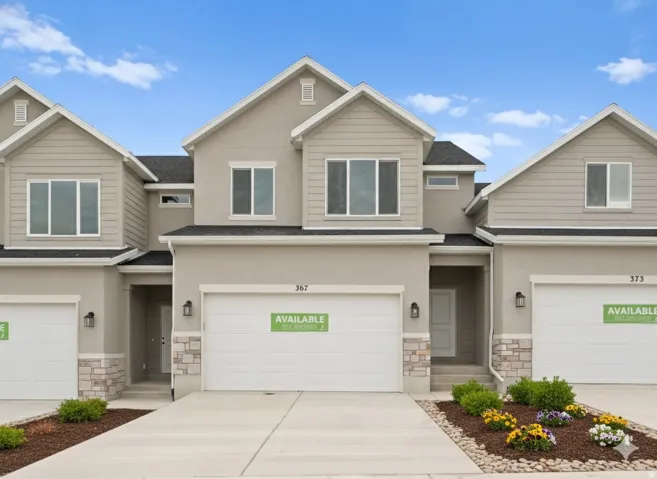 Craftsman-style home with stone siding, a shingled roof, an attached garage, and driveway