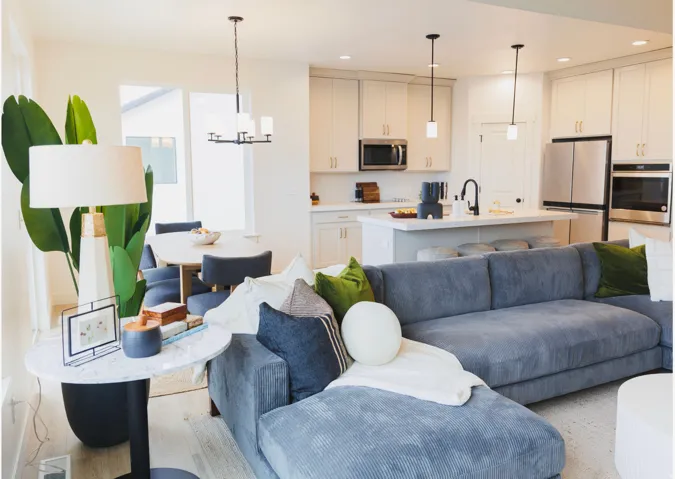 Living area with light wood-style flooring and hanging lights