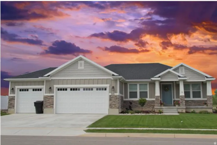 Craftsman inspired home featuring board and batten siding, stone siding, a lawn, and concrete driveway