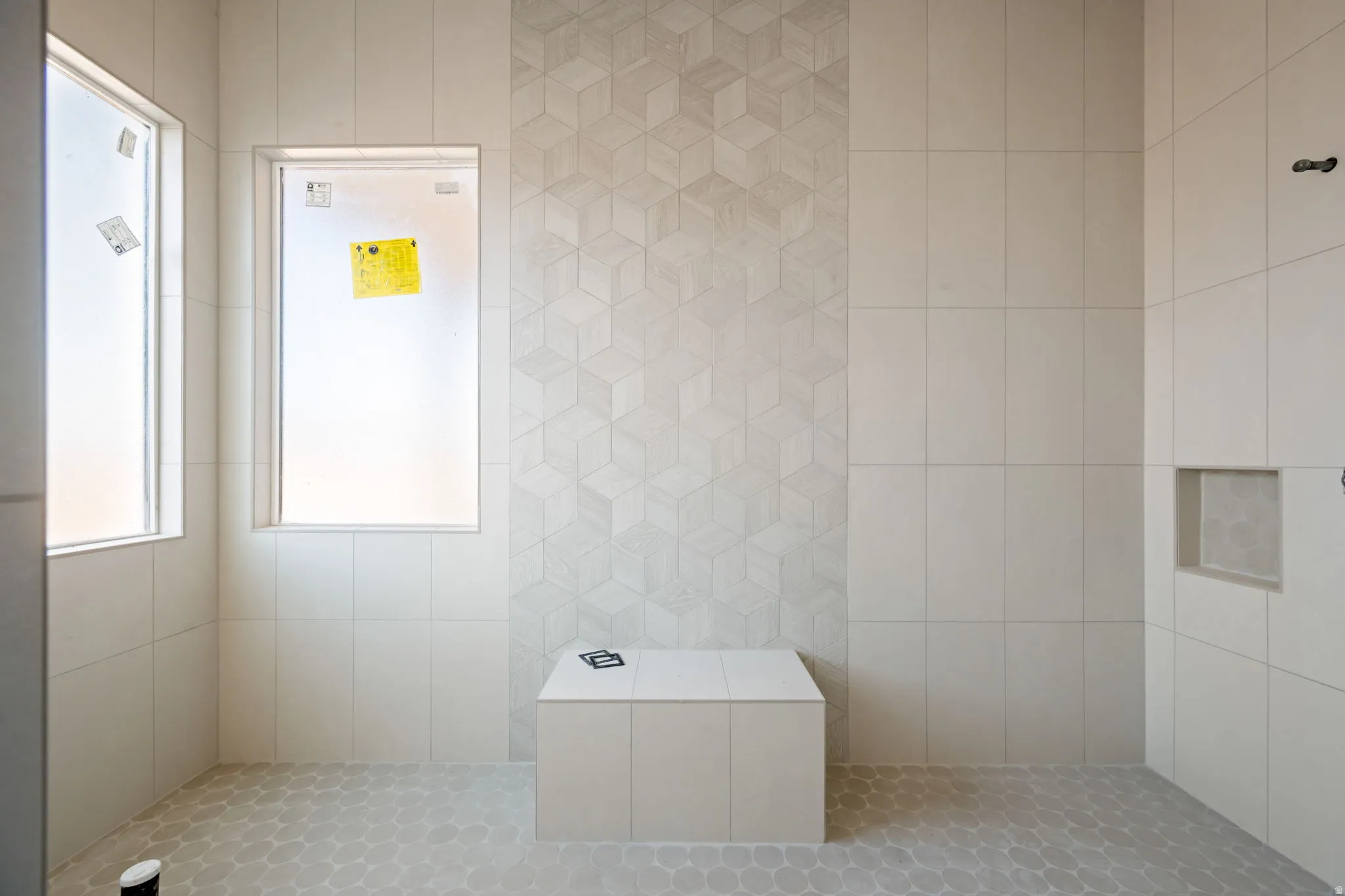 Full bath featuring tile walls and a tile shower