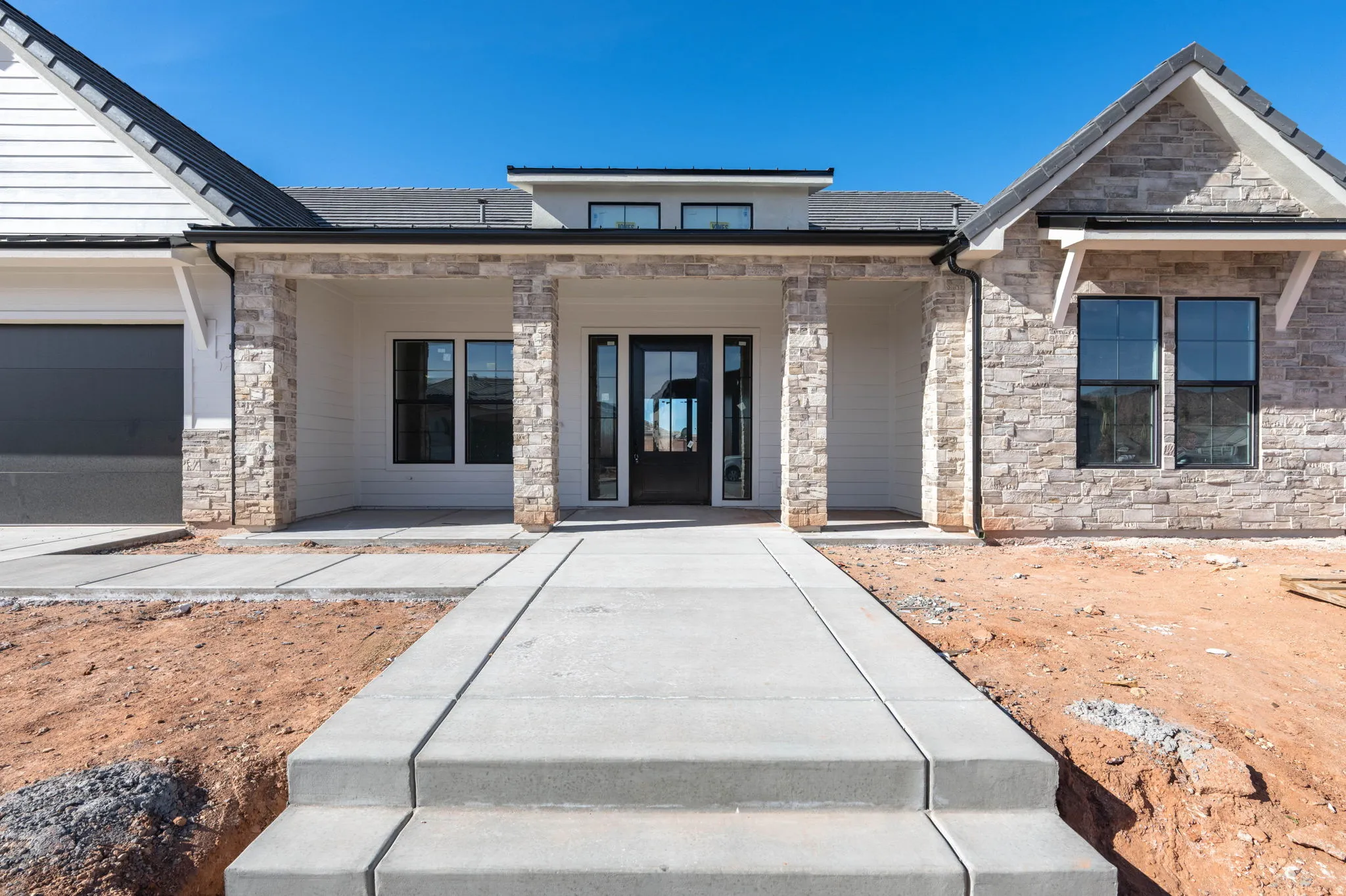Entrance to property featuring stone siding
