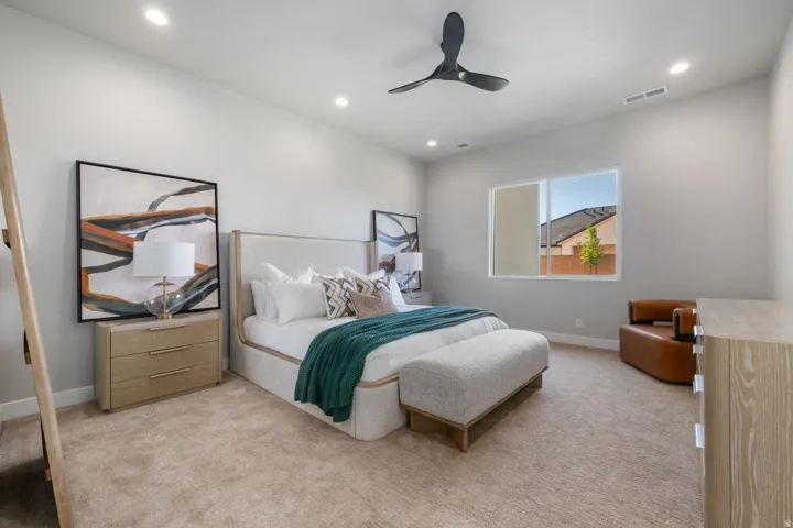 Plush carpeting, recessed lighting, and a modern ceiling fan