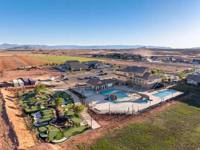 Expansive outdoor recreational area featuring a miniature golf course, multiple swimming pools, and a central clubhouse structure