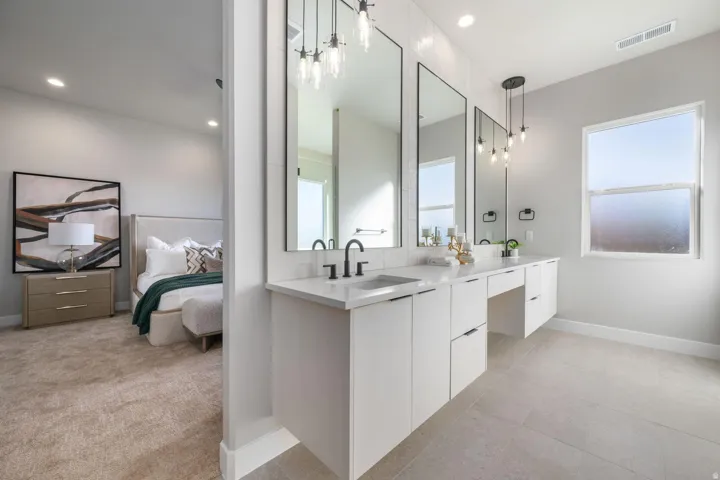 Dual vanity with matte black fixtures, quartz countertops, and integrated sinks