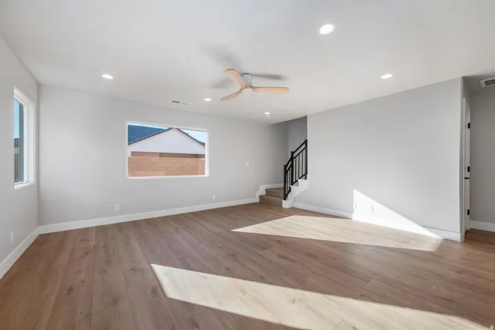 Spacious area featuring light wood-finish flooring, recessed lighting, and a modern ceiling fan
