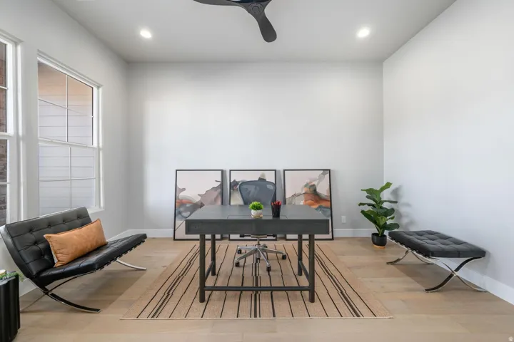 Recessed lighting, ceiling fan, wood-finish flooring, and white trim