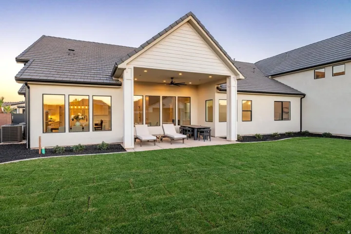 Expansive rear yard featuring a manicured lawn