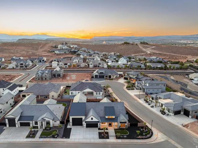 Modern residential neighborhood with a variety of architectural styles, paved streets, and a desert landscape backdrop