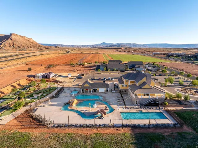 Large community pool, separate children's pool with water features, extensive sun deck with lounge chairs, miniature golf course, and a clubhouse with covered outdoor seating
