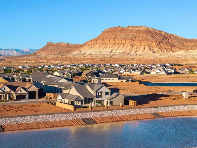 View of mountain background featuring nearby suburban area and a large body of water
