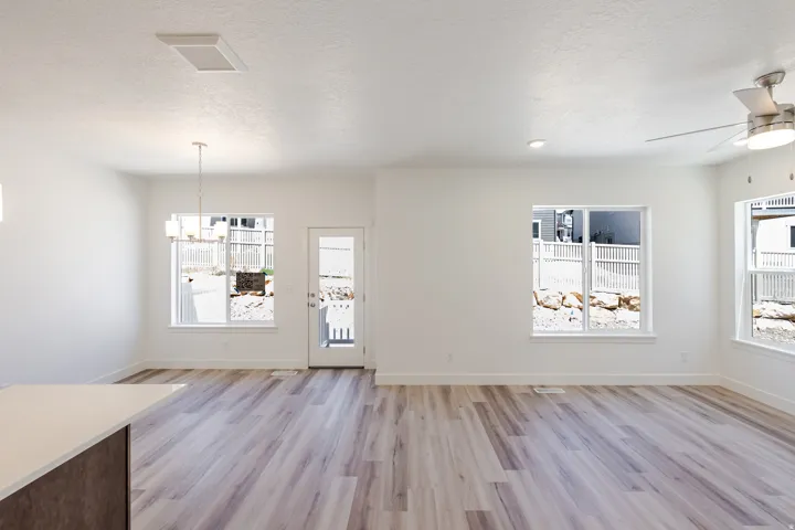 Open-concept living space featuring wood-finish flooring, recessed lighting, and a ceiling fan
