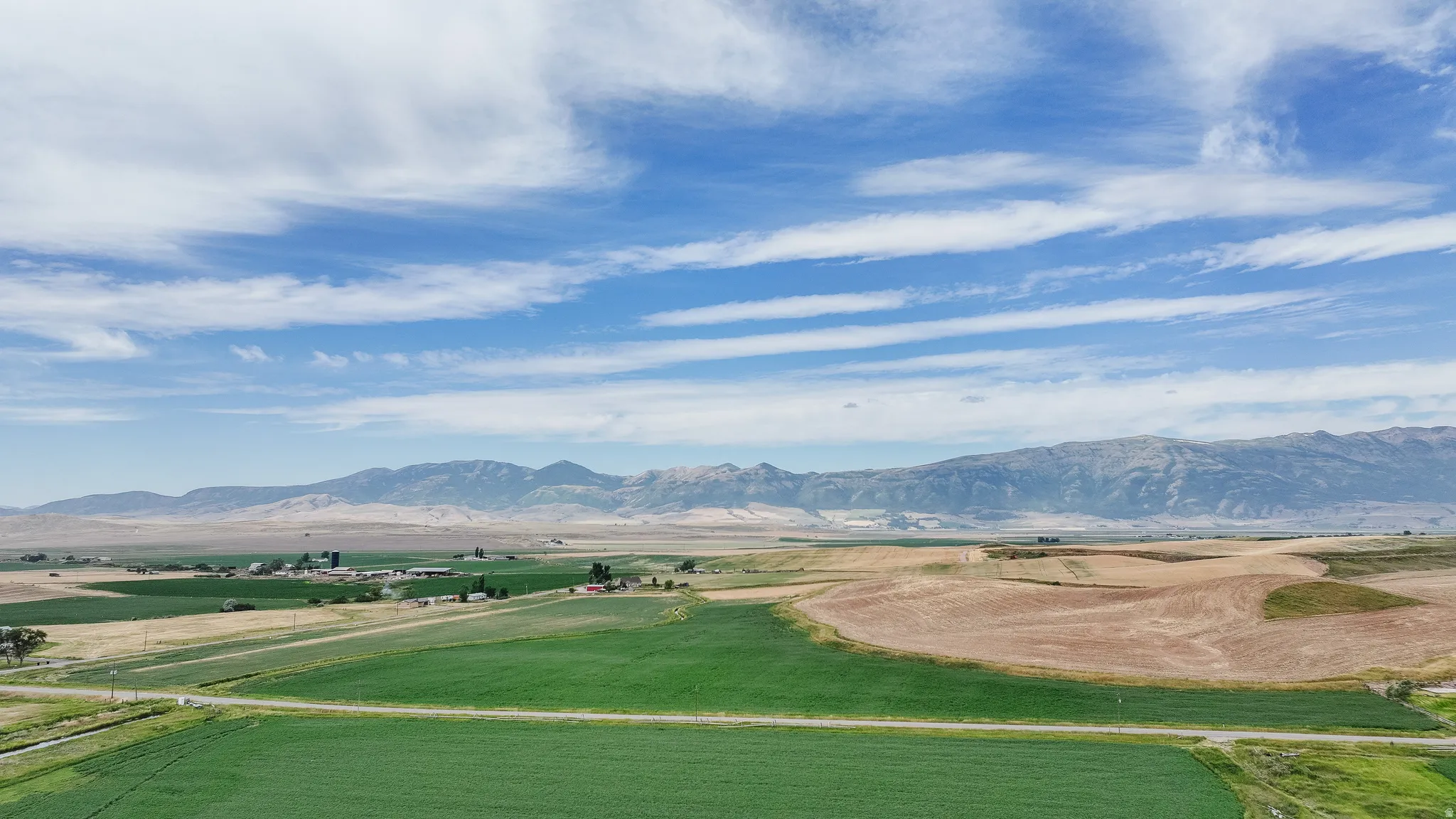View of mountain backdrop featuring rural landscape