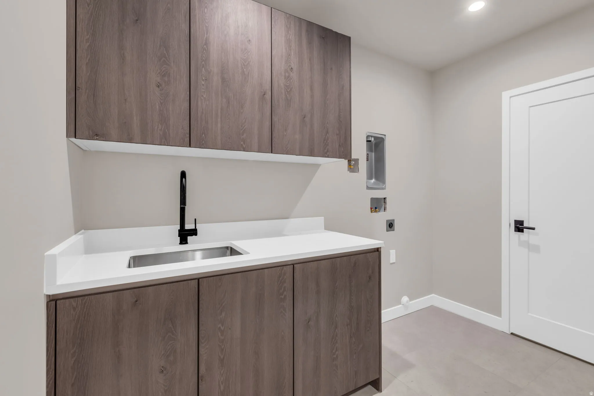 Laundry room with cabinet space, hookup for an electric dryer, washer hookup, and recessed lighting