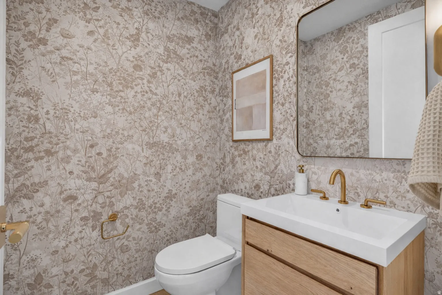 Bathroom featuring vanity and wallpapered walls