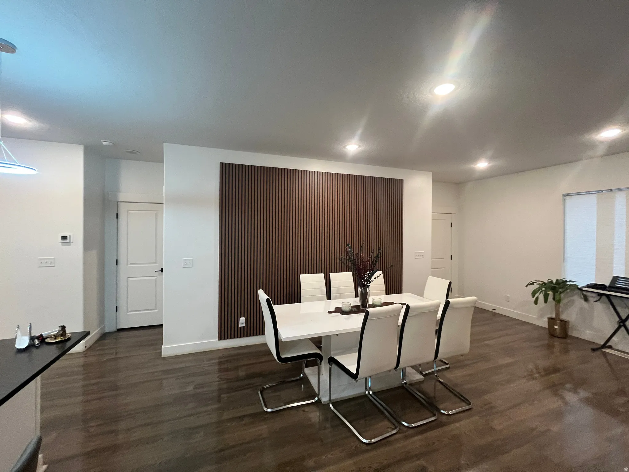 Dining space featuring dark wood finished floors and recessed lighting