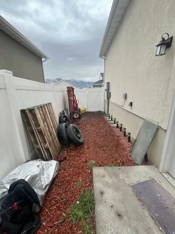Fenced backyard with a gate and a patio area