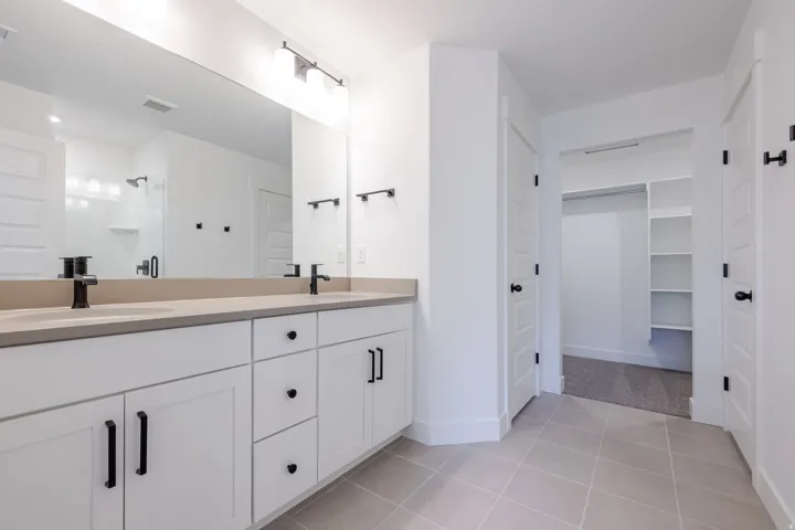 Dual vanity with matte black fixtures and light-toned countertop