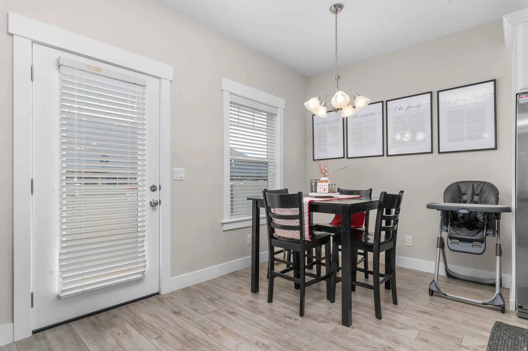 Dining space with hanging lights and light wood finished floors