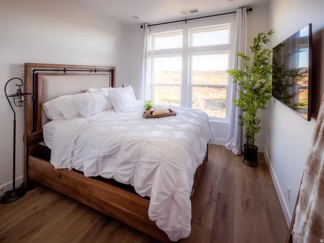 Bedroom featuring baseboards and dark wood-style flooring