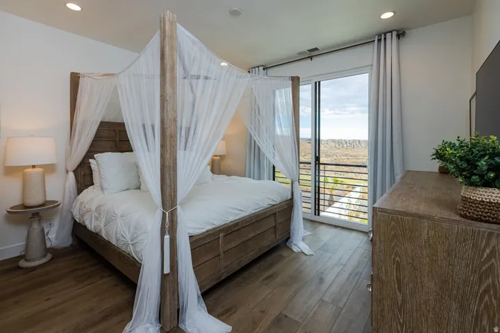 Bedroom featuring recessed lighting, dark wood-style floors, and access to exterior