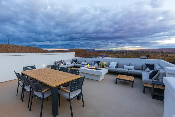 View of patio / terrace featuring outdoor lounge area, a mountain view, and an outdoor fire pit