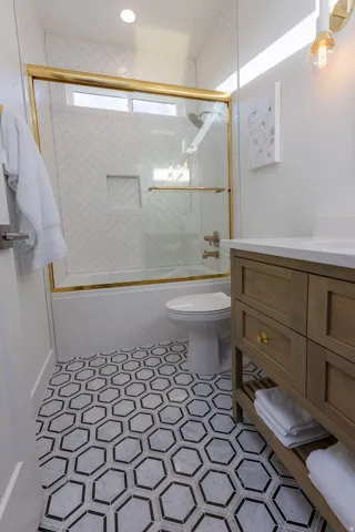 Full bathroom featuring combined bath / shower with glass door and vanity