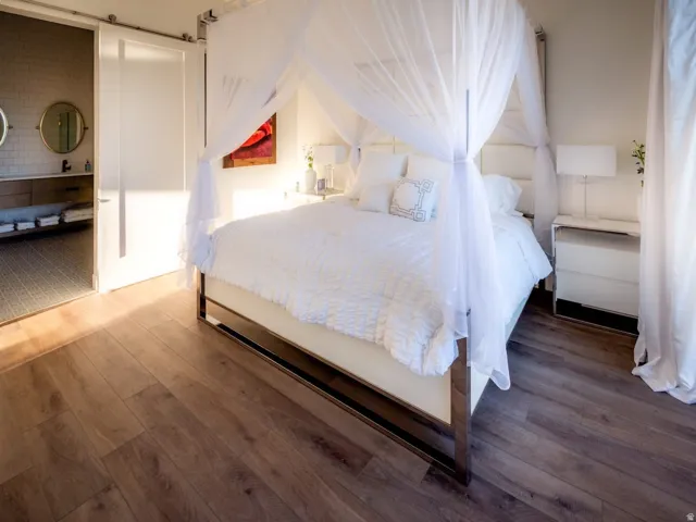 Bedroom with hardwood / wood-style flooring and a barn door