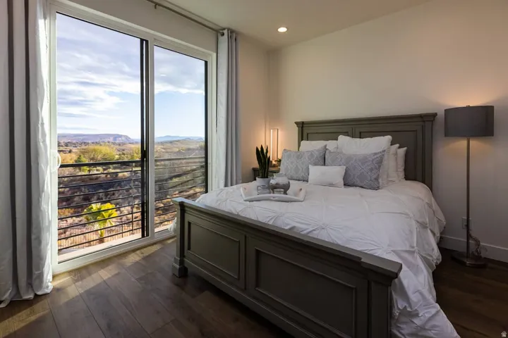 Bedroom with dark wood-style flooring, access to outside, recessed lighting, and a mountain view