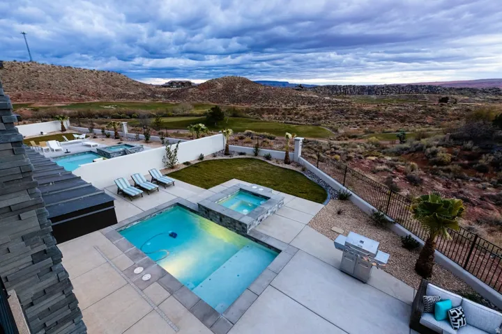 Integrated pool / spa featuring a patio, a fenced backyard, a mountain view, and outdoor dining area