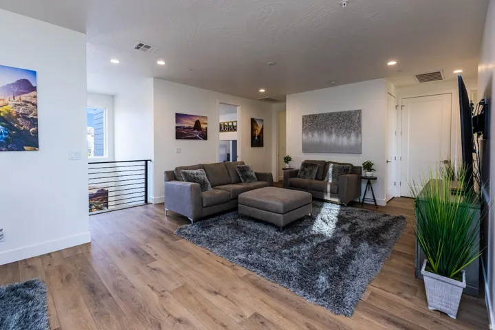 Living area featuring wood finished floors and recessed lighting