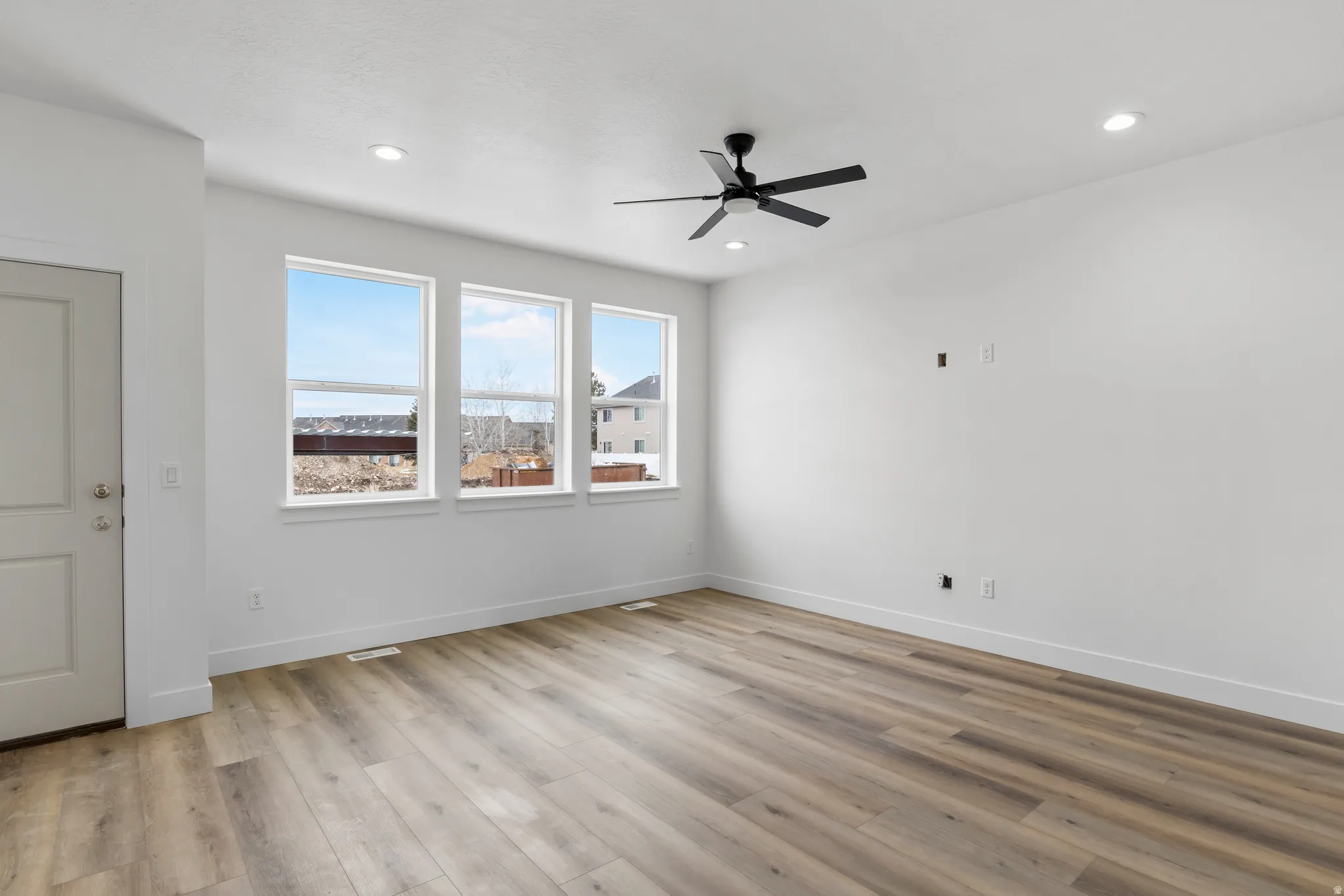 Spare room with ceiling fan, light wood finished floors, and recessed lighting
