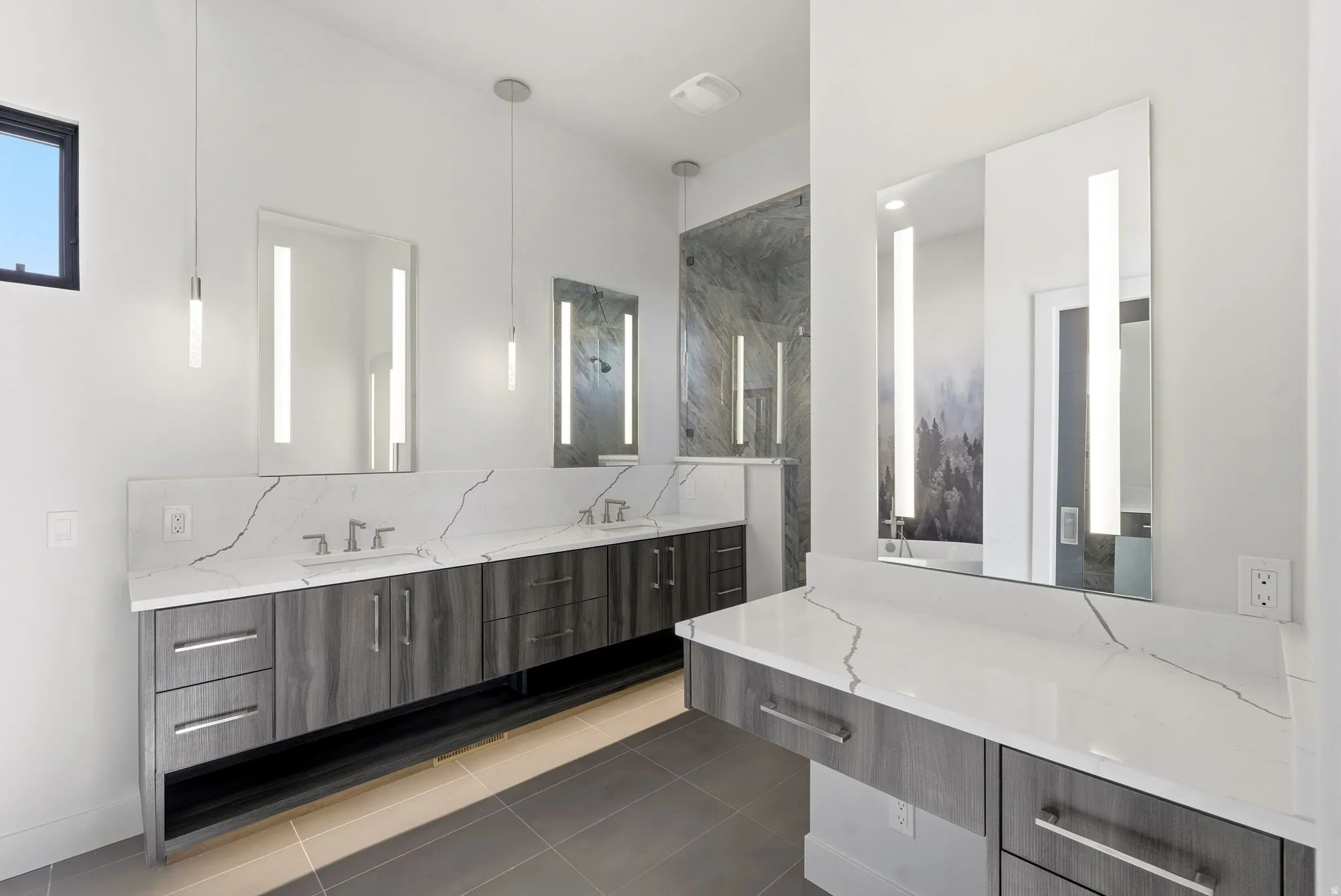 Full bath featuring double vanity, a marble finish shower, light tile patterned floors, and decorative backsplash
