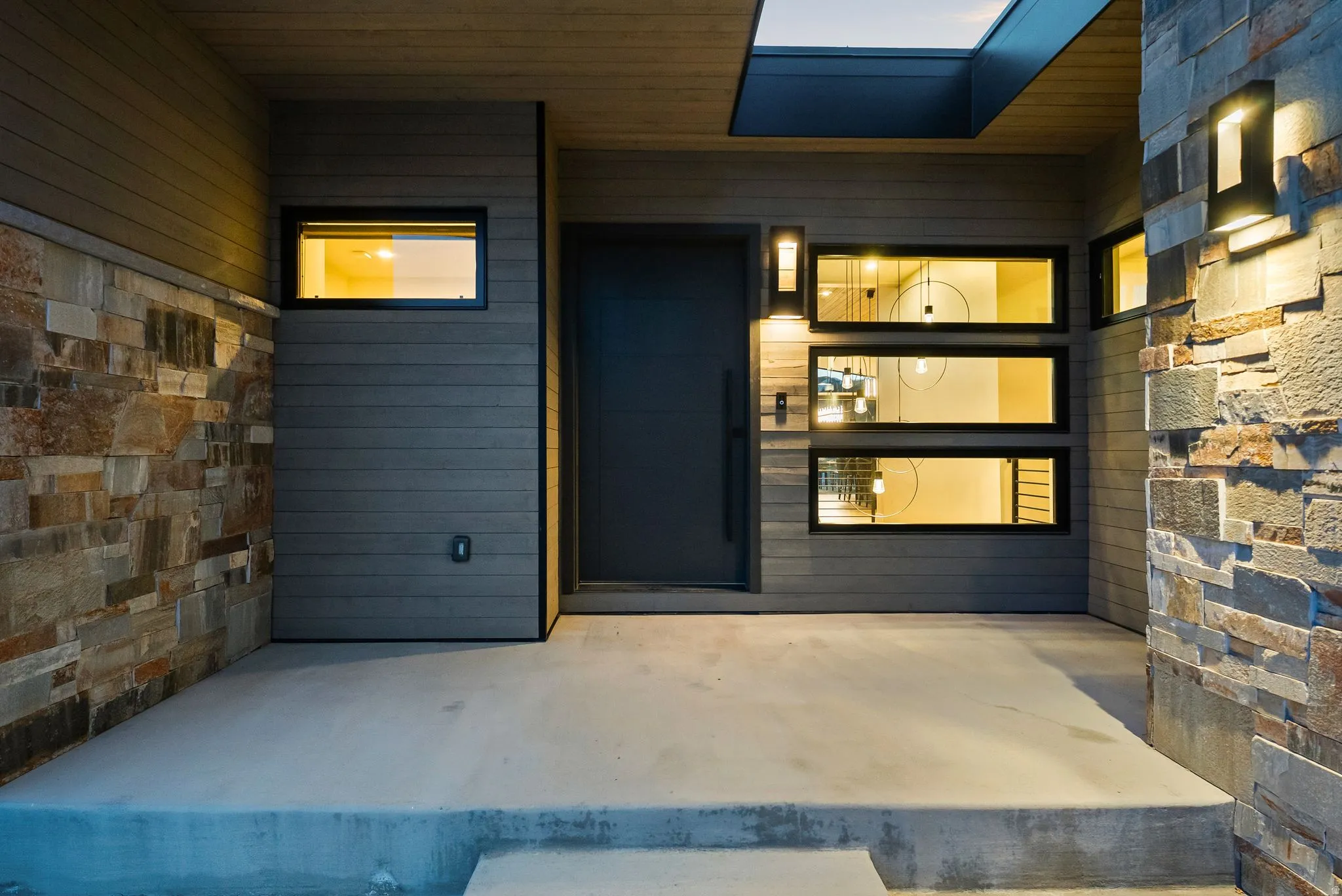 Property entrance with a patio