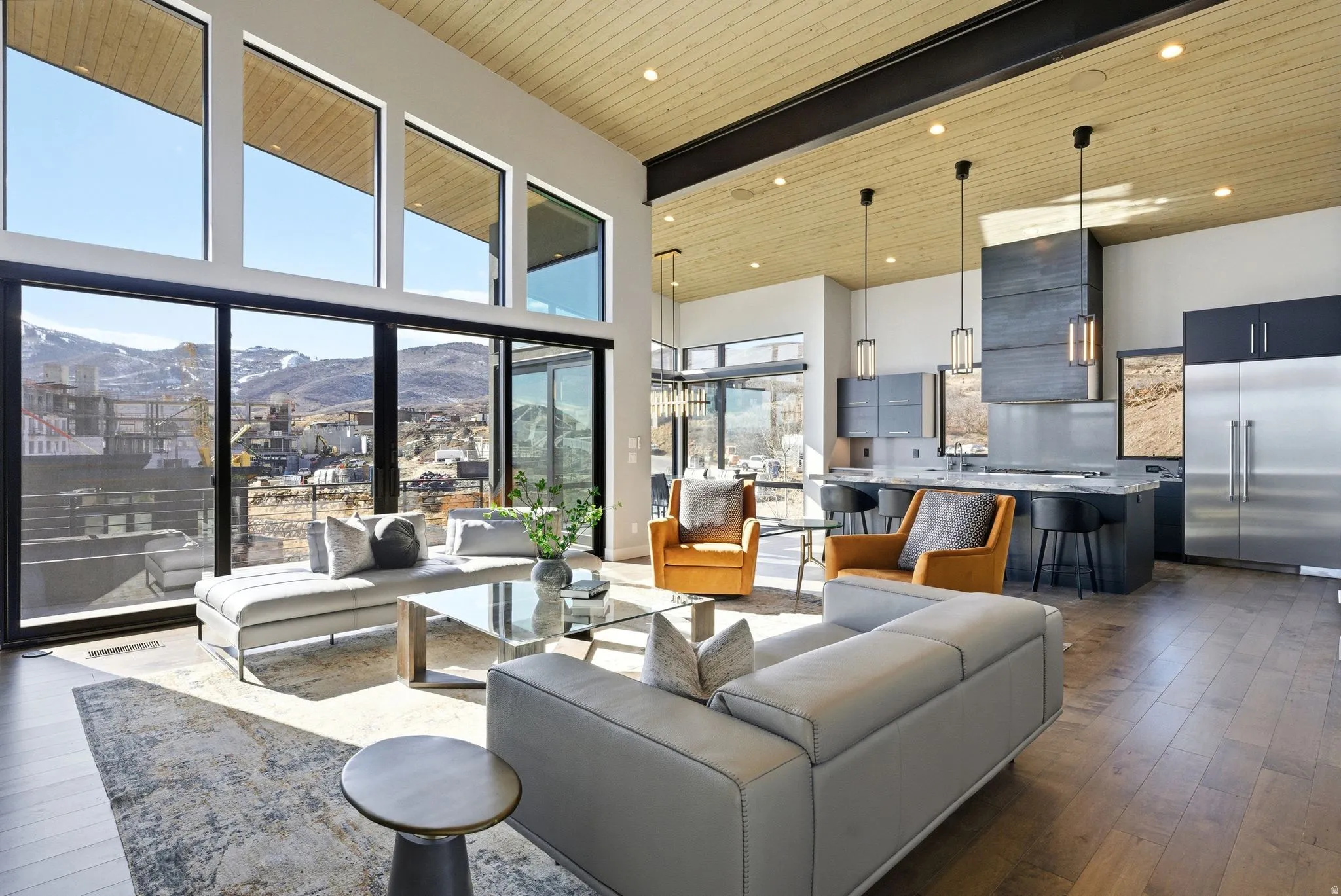 Living area with a mountain view, dark wood finished floors, a high wood beamed ceiling, and recessed lighting