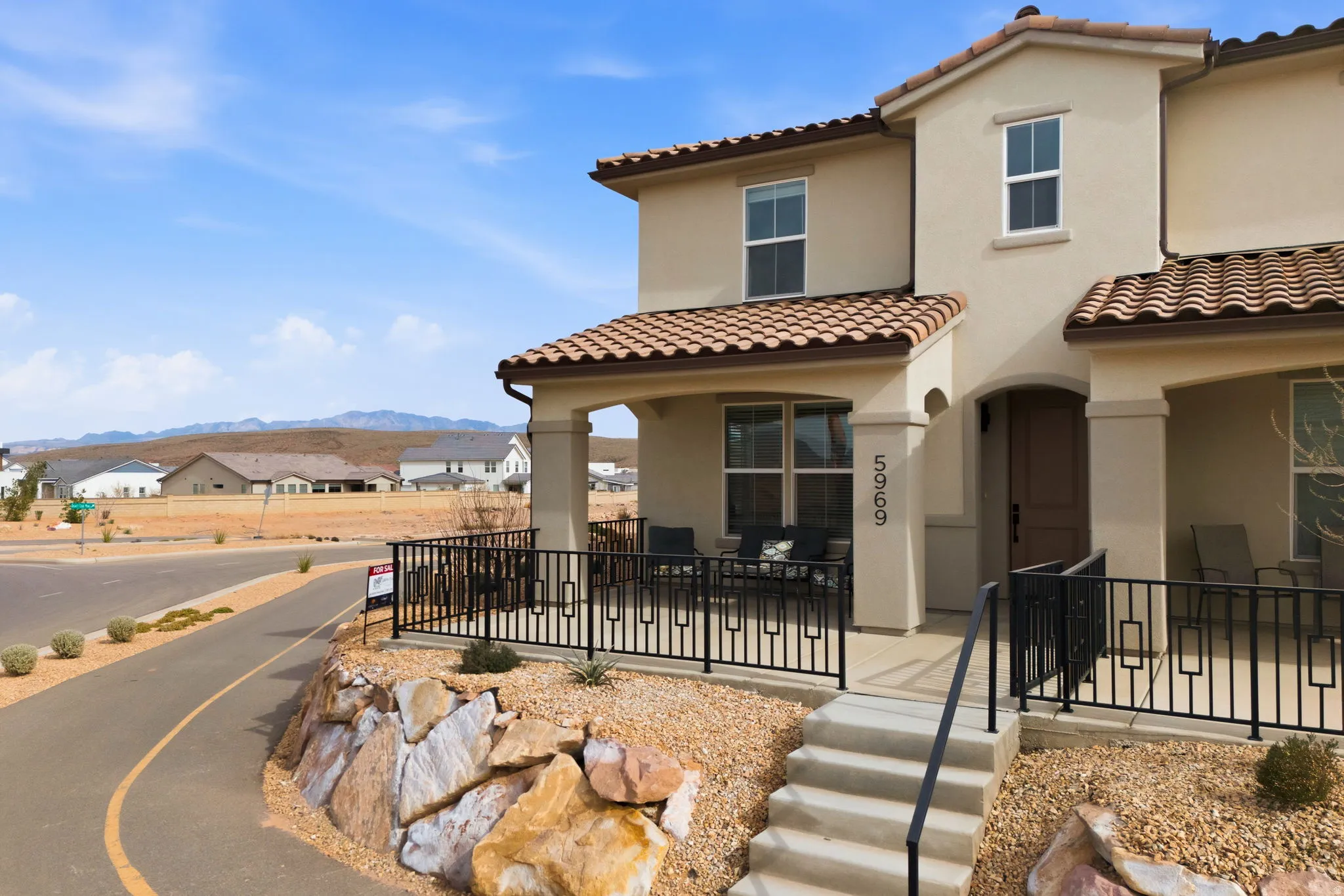 Mediterranean / spanish house featuring a residential view, a tile roof, and stucco siding